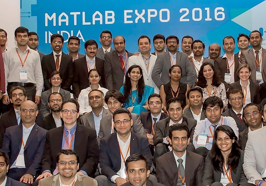 Group photo staff members in front of a sign for MATLAB EXPO 2016.
